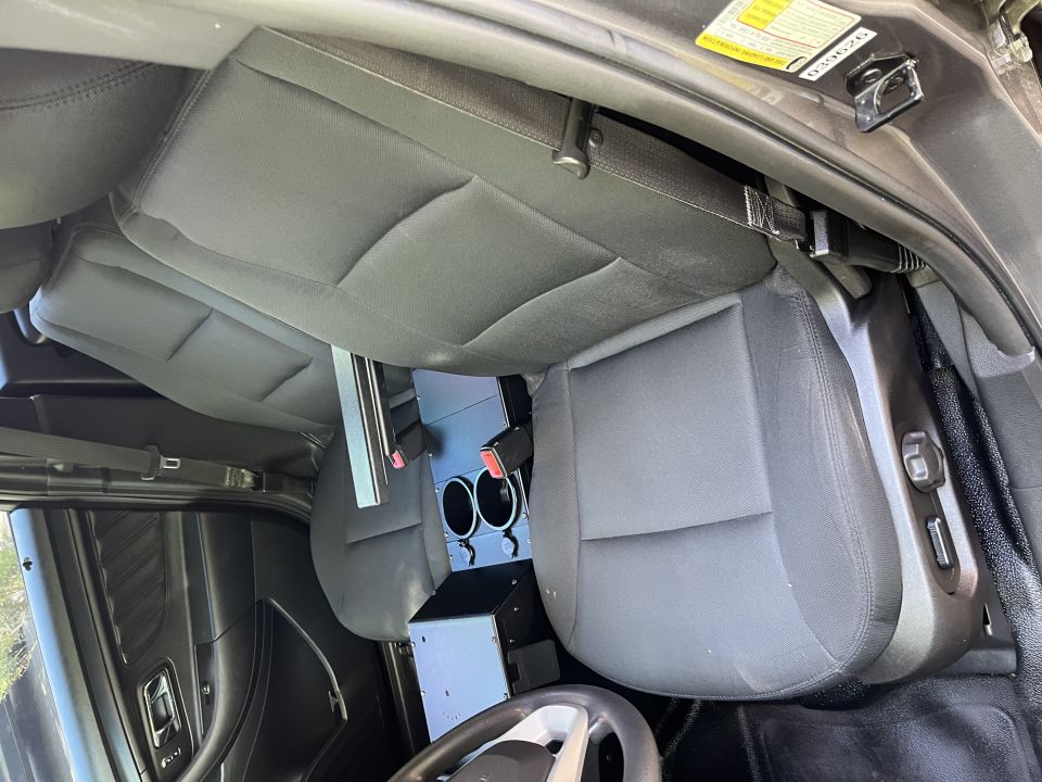 2001 Ford Crown Victoria interior, showing front seats, center console with cup holders, and steering wheel
