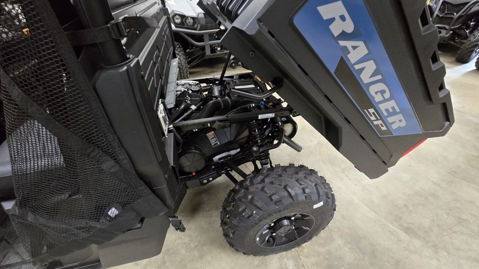 Polaris Ranger SP side-by-side with hood open, engine visible. Another side-by-side is in the background