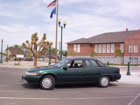 1995 Mercury Sable - Parked next to a flagpole.