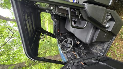 2025 Polaris RANGER - The interior of a utility task vehicle is shown, with a focus on the driver's area and seating.