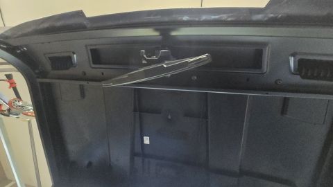 2025 Polaris RANGER - The underside of a vehicle's hood is shown, revealing the latch mechanism and structural supports.