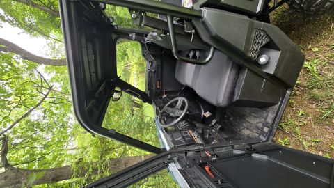 2025 Polaris RANGER - Interior view of a UTV, showing the cabin and an open door. Supermotors.net logo is present.