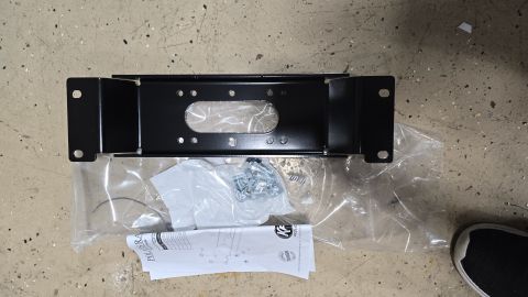 2025 Polaris RANGER - KFI winch mount kit, including hardware and installation instructions, shown on a concrete surface.
