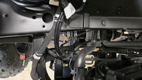 2025 Polaris RANGER - Close-up view of the undercarriage, showing winch components and wiring harness, with a SuperMotors watermark.