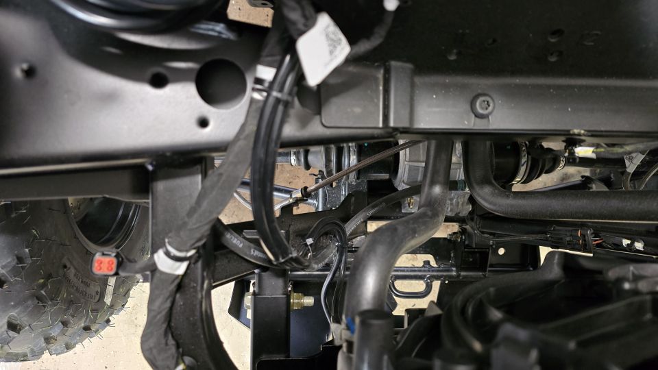 Undercarriage view of winch and wiring on a vehicle part