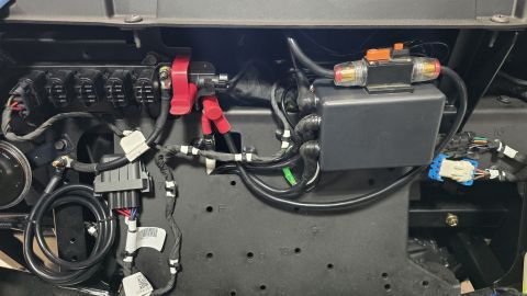 2025 Polaris RANGER - Close-up of vehicle electrical system components, including fuse block and wiring.