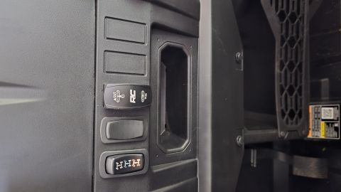 2025 Polaris RANGER - Close-up of interior controls showing a Rough Country winch switch and a gear selector with HHH markings.