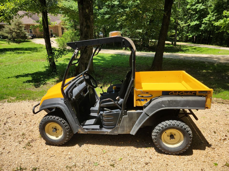 Yellow Cub Cadet utility vehicle with 4x4 badging and a dump bed