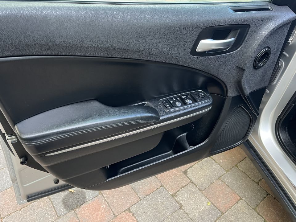 Driver door panel of a sedan with power window and lock controls