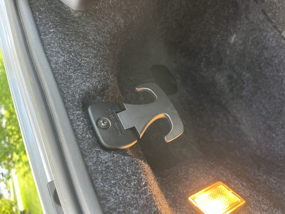 Plastic cargo hook on the trunk wall of a Dodge Charger