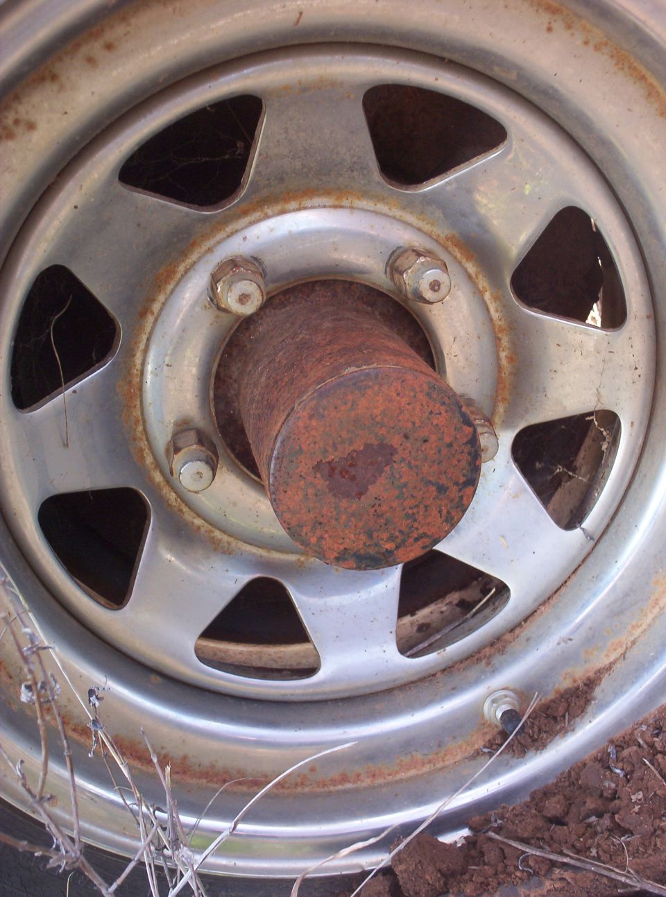 close-up of rusty wheel hub with lug nuts