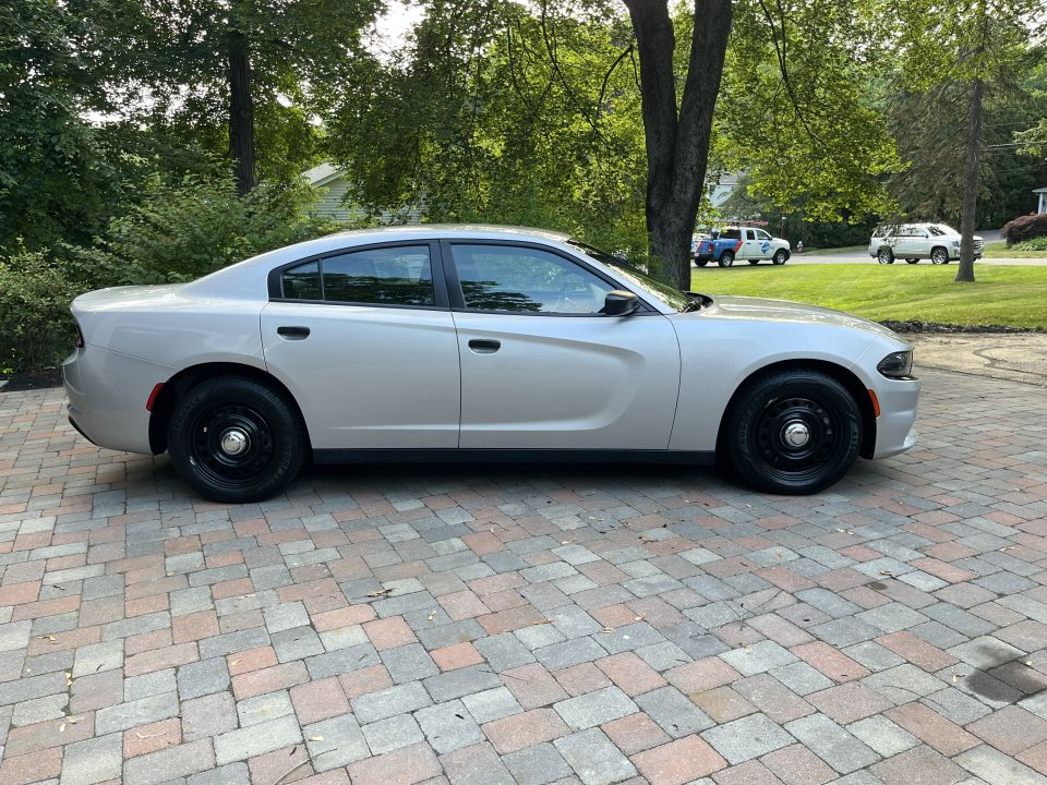 Silver Dodge Charger sedan passenger-side profile view