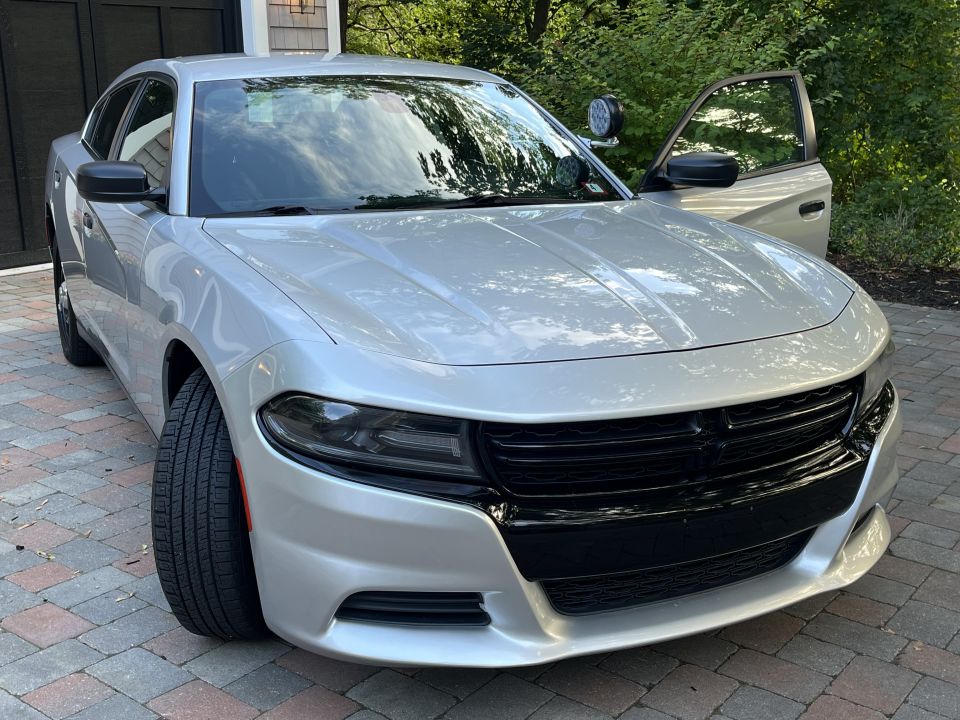 Silver Dodge Charger front three-quarter view with door ajar