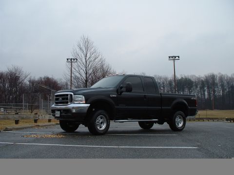 2001 Ford F-350 - Black 2001 Ford F-350 Super Duty pickup truck parked in an outdoor lot.
