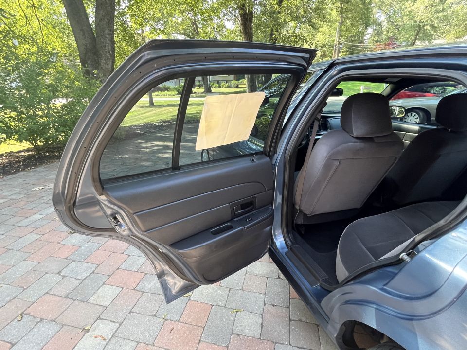 Rear interior view of a car with open doors showing seats and door panels