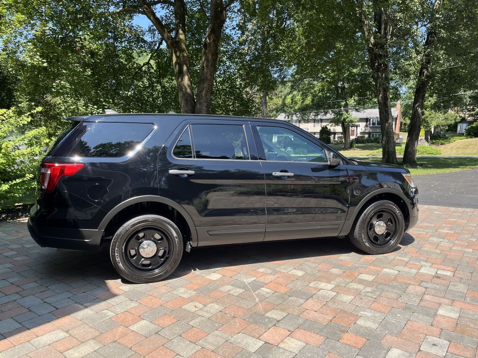 Black Ford Explorer SUV passenger side profile view