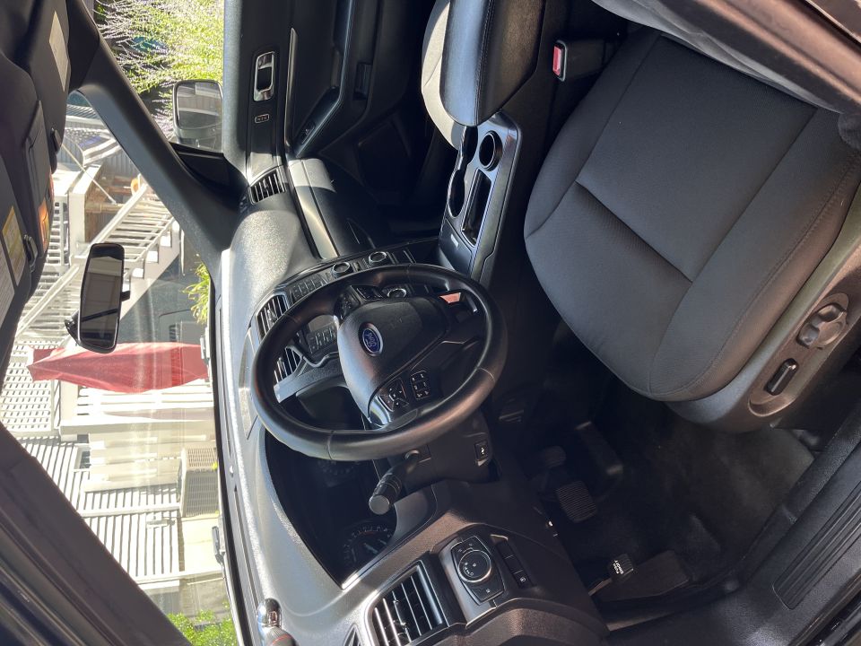 Interior of Ford Explorer showing steering wheel, dash and front seat