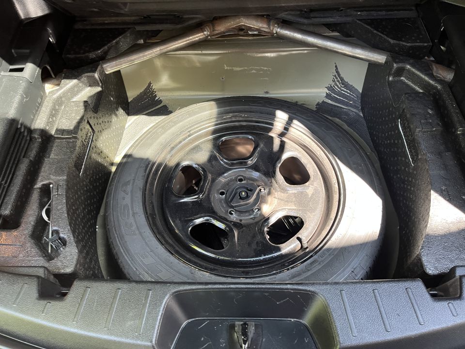 Spare tire well with a spare tire and jack