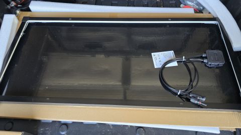2024 Subaru Impreza - A solar panel is shown in its packaging, with connecting cables and a junction box attached.