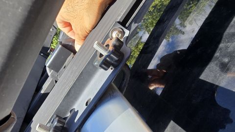 2024 Subaru Impreza - Close-up of a metal bracket with wing nuts, suggesting an accessory attachment rather than a vehicle part.