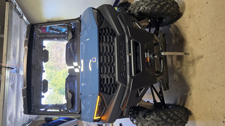 Polaris RZR side-by-side parked in a garage, front view