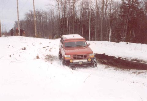 1995 Ford Bronco - This 1995 Ford Bronco navigates a snowy trail, displaying a CAT logo on its front bumper.