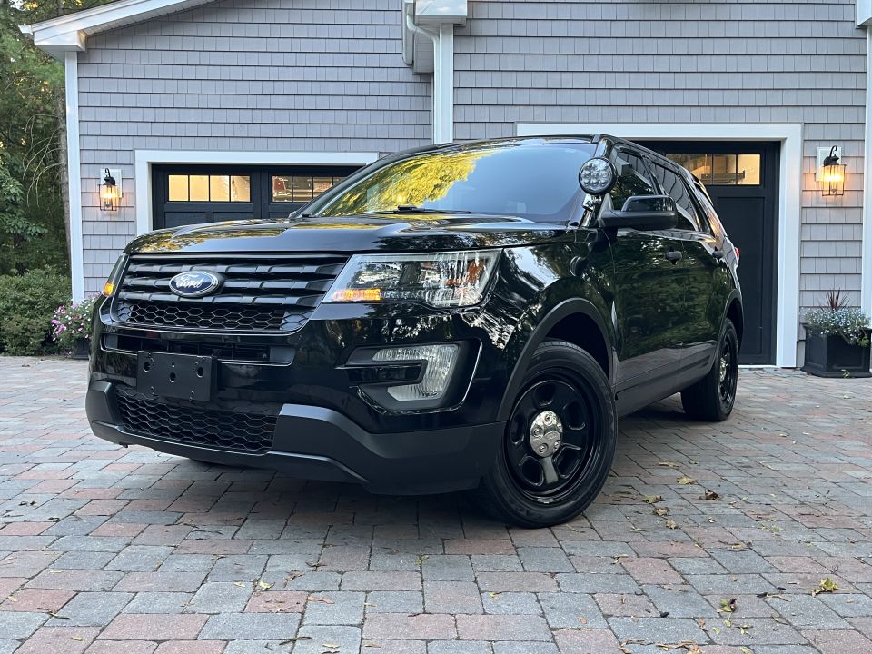 Black Ford Explorer police SUV parked in driveway