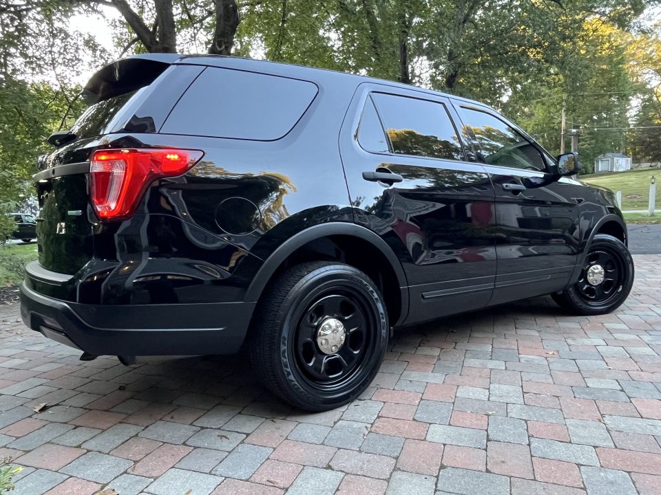 Black SUV parked on a paver driveway