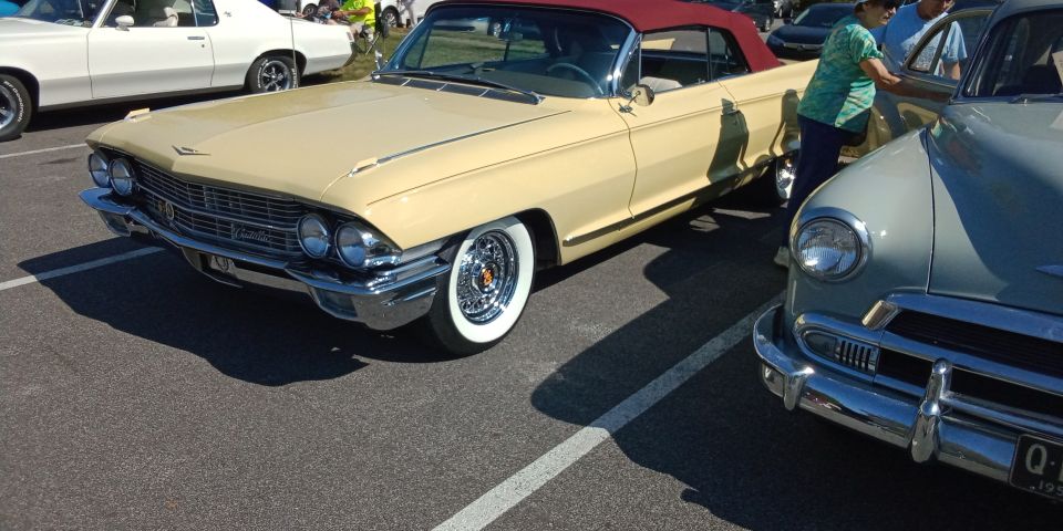 1959 Cadillac Eldorado Biarritz convertible, tan exterior, red top, chrome wire wheels, parked next to a light blue car
