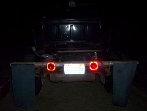 1978 Ford Bronco - Custom rear end of a vehicle at night, showing modified fenders and taillights.