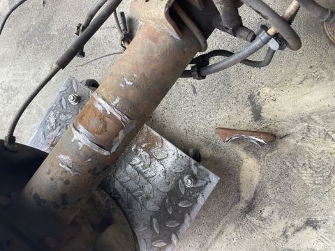 1979 Ford Bronco - Close-up of a heavily rusted axle component with evidence of repair work.