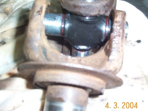 1992 Ford Bronco - After removing the caps, I positioned the u-joint betweent the two axle pieces. You may have to work it around a little to get it to fit.