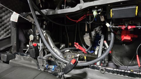 2025 Polaris RANGER - Close-up of vehicle interior showing wiring, battery, and seatbelt mechanism.