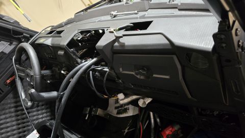 2025 Polaris RANGER - Interior view of a vehicle's dashboard with visible wiring and disassembled parts.