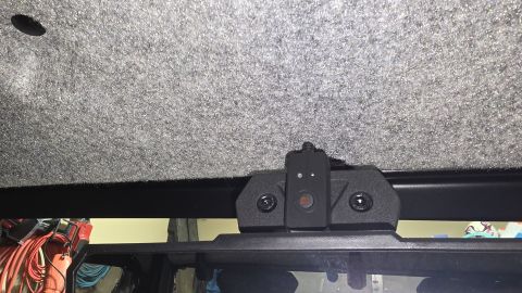 2025 Polaris RANGER - A dash cam mount is secured to the fuzzy interior ceiling of a vehicle.