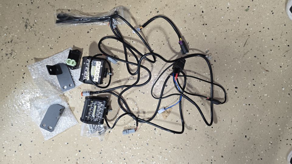 Two LED backup lights with wiring and mounting brackets