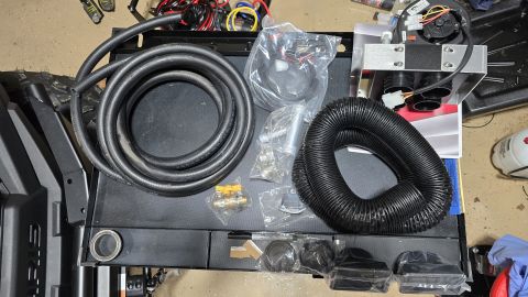 2025 Polaris RANGER - Various components of an aftermarket vehicle heater kit are displayed, including flexible ducting and a blower assembly.