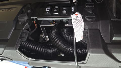 2025 Polaris RANGER - Vehicle interior with flexible ducts and a switch panel, possibly for an aftermarket accessory.