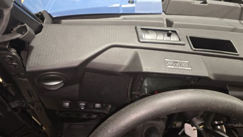 2025 Polaris RANGER - The interior of a utility task vehicle shows the dashboard with air vents and control switches.