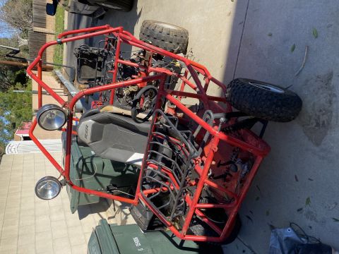 1900 Yugo GVX - This red off-road buggy features a prominent roll cage and two seats.