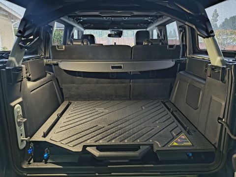 2023 Ford Bronco - The cargo area of a 2023 Ford Bronco features a textured floor mat and a cargo cover.