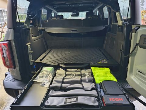 2023 Ford Bronco - The cargo area of a Ford Bronco is organized with pull-out drawers containing various items and accessories.