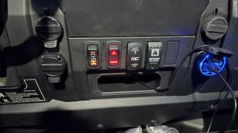2025 Polaris RANGER - Dashboard controls and power outlets in a vehicle, including hazard and auxiliary switches.