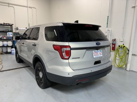 2001 Ford Crown Victoria - Silver Ford Explorer Police Interceptor Utility with black trim and wheels is parked indoors.