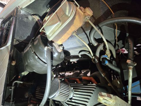 1974 Ford Bronco - Close-up of the brake booster and master cylinder assembly in a vehicle's engine bay.