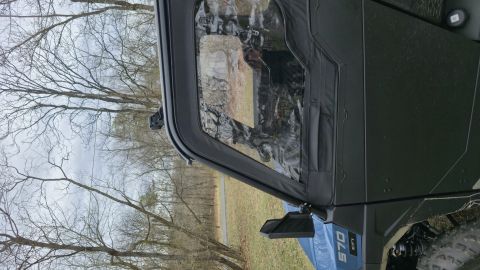 2025 Polaris RANGER - View of the driver's side door and interior of a utility vehicle, with a clear vinyl window.