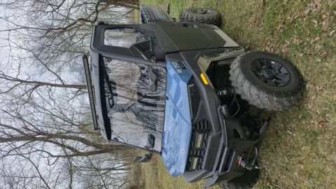 2025 Polaris RANGER - This side-by-side utility vehicle is parked outdoors on a grassy area with trees in the background.