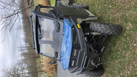 2025 Polaris RANGER - Side-by-side utility vehicle parked outdoors on grass.