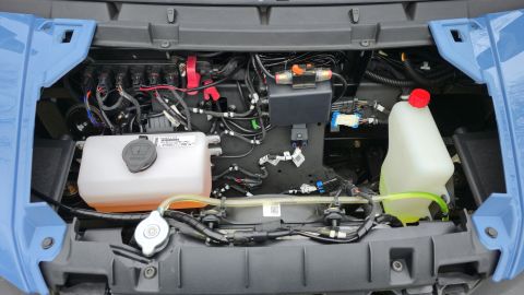 2025 Polaris RANGER - Vehicle's engine bay with various fluid reservoirs and complex wiring visible.