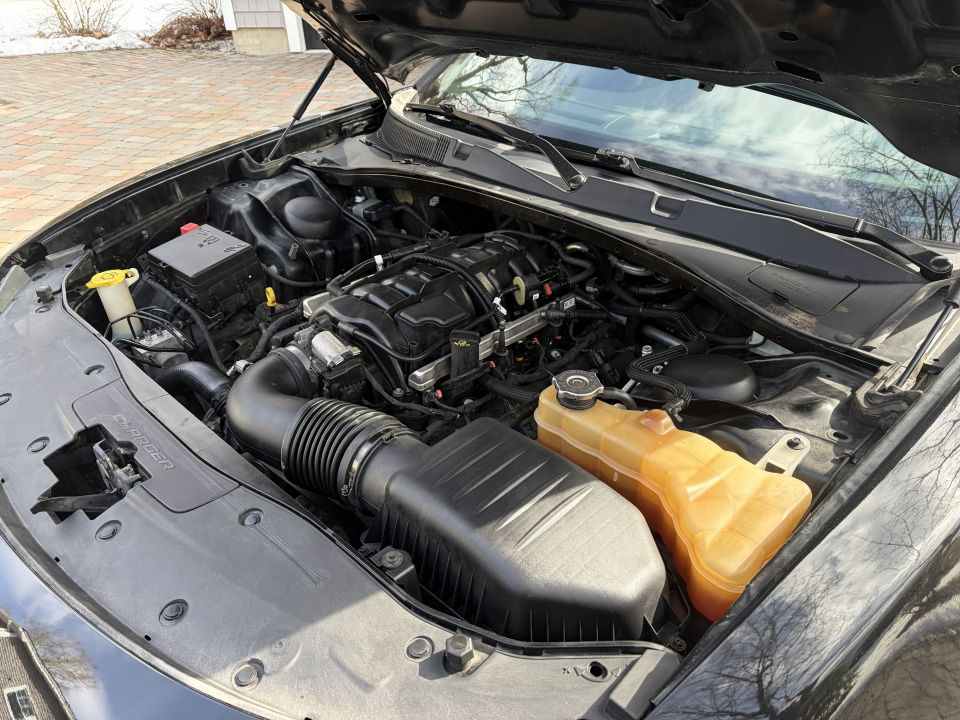 Black Dodge Charger engine bay with hood open